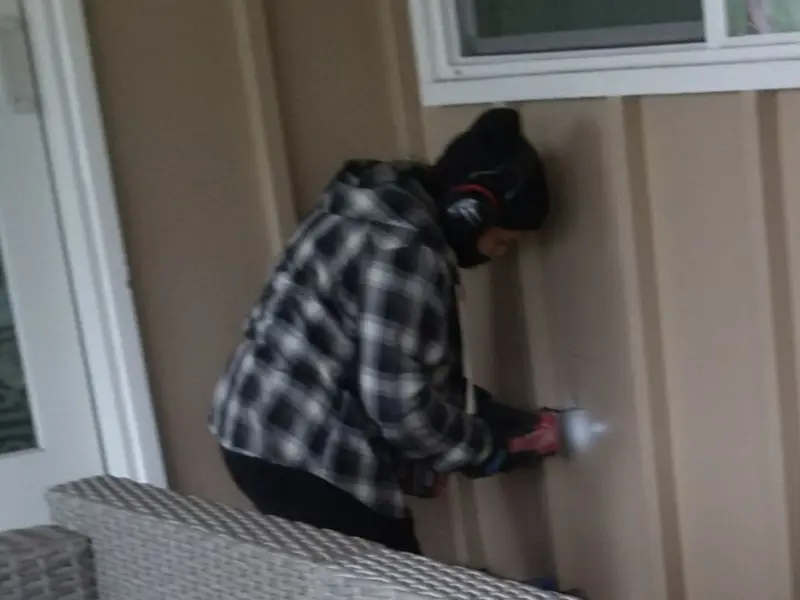 Professional electrician installing an exterior outlet in Versailles